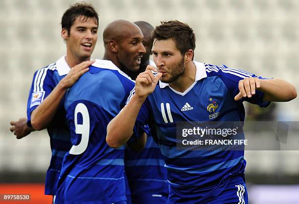 French forward Andre-Pierre Gignac celebrates with teammates Nicolas Anelka and Yoann Gourcuff after scoring a goal during the World Cup 2010...