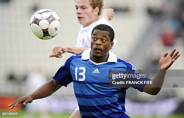 French defender Patrice Evra vies with an unidentified Faroe Islands' player during the World Cup 2010 qualifying football match France vs. Faroe...