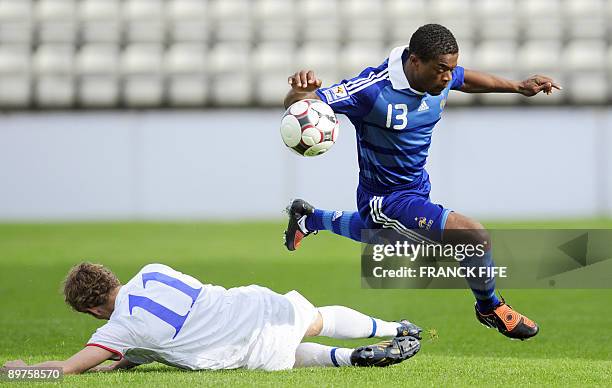 French defender Patrice Evra jumps in front of Faroe's forward Bogi Lokin during the World Cup 2010 qualifying football match France vs. Faroe...