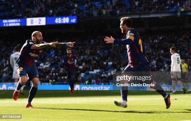 Aleix Vidal of Barcelona celebrates after scoring his sides third goal with Lionel Messi of Barcelona during the La Liga match between Real Madrid...