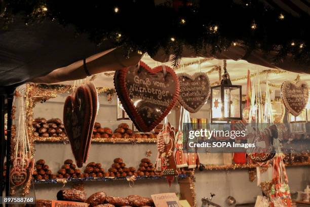 Handcrafted Christmas goods hang in one of the numerous stalls set up in the Christmas market located in the city center. Arguably Germanys most...