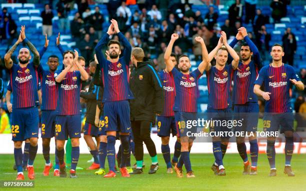 Barcelona's players celebrate at the end of the Spanish League "Clasico" football match Real Madrid CF vs FC Barcelona at the Santiago Bernabeu...
