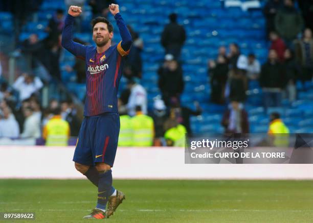 Barcelona's Argentinian forward Lionel Messi celebrates at the end of the Spanish League "Clasico" football match Real Madrid CF vs FC Barcelona at...