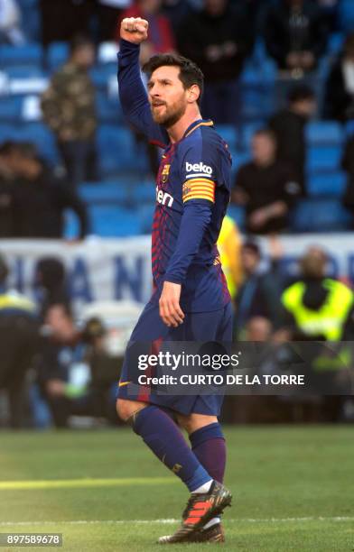Barcelona's Argentinian forward Lionel Messi celebrates at the end of the Spanish League "Clasico" football match Real Madrid CF vs FC Barcelona at...