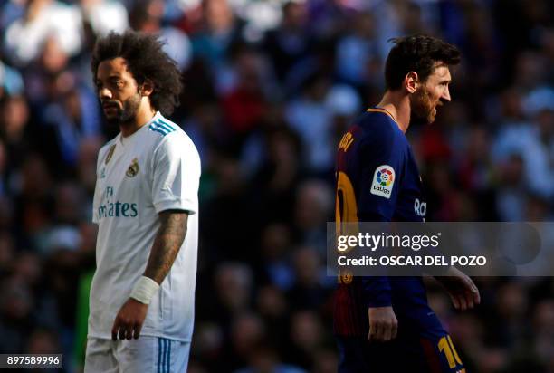 Real Madrid's Brazilian defender Marcelo and Barcelona's Argentinian forward Lionel Messi react during the Spanish League "Clasico" football match...