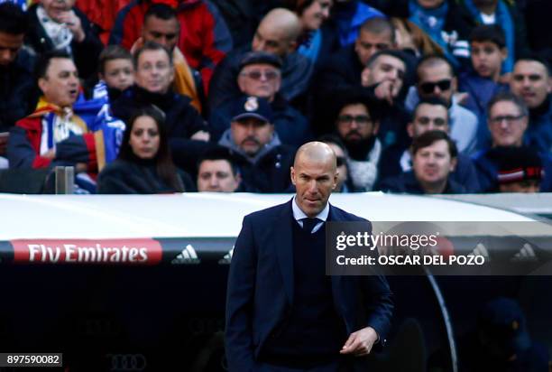 Real Madrid's French coach Zinedine Zidane reacts during the Spanish League "Clasico" football match Real Madrid CF vs FC Barcelona at the Santiago...