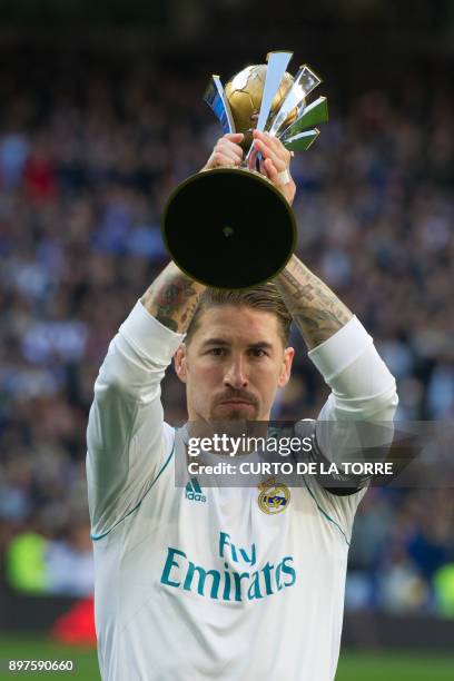Real Madrid's Spanish defender Sergio Ramos receives the FIFA Club World Cup 2017 award before the Spanish League "Clasico" football match Real...