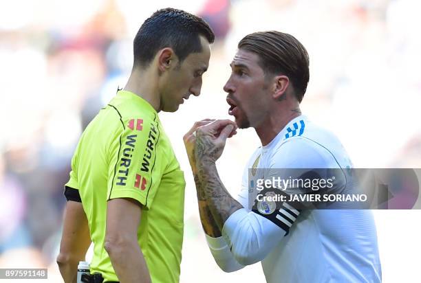 Real Madrid's Spanish defender Sergio Ramos argues with referee Jose Maria Sanchez Martinez during the Spanish League "Clasico" football match Real...
