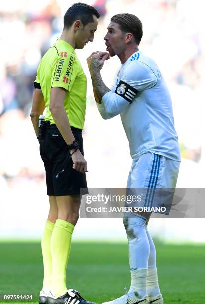 Real Madrid's Spanish defender Sergio Ramos argues with referee Jose Maria Sanchez Martinez during the Spanish League "Clasico" football match Real...