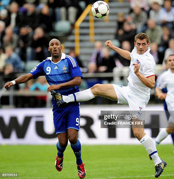 French forward Nicolas Anelka vies with Faroe's forward Frodi Benjaminsen during the World Cup 2010 qualifying football match France vs. Faroe...