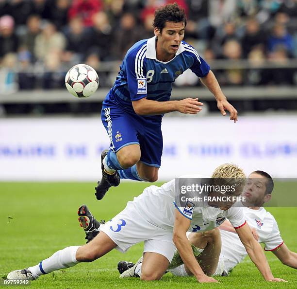 French midfielder Yoann Gourcuff is tackled by Faroe's defenders Johan Davidsen and Atli Gregersen during the World Cup 2010 qualifying football...