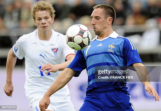 French forward Franck Ribery vies with Faroe's midfielder Einar Hansen during the World Cup 2010 qualifying football match France vs. Faroe Islands,...