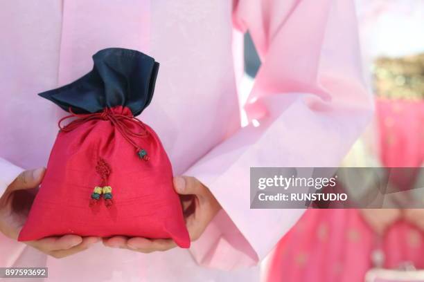 man in korean traditional clothes holding lucky bag - chuseok stock pictures, royalty-free photos & images