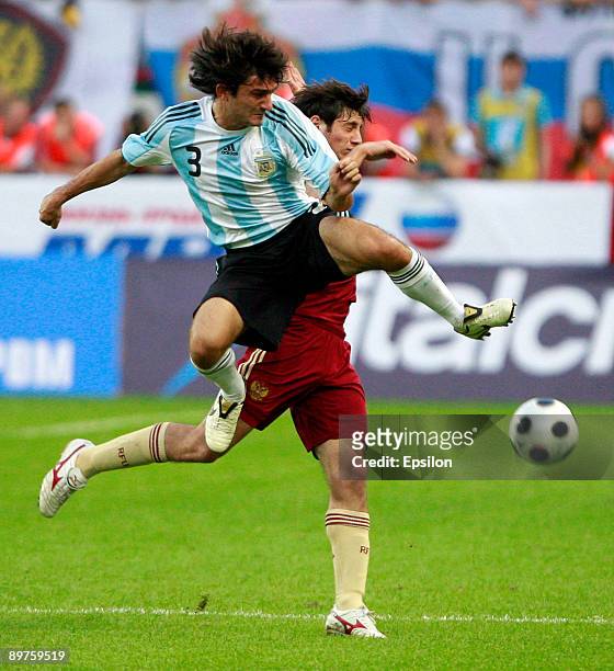 Alan Dzagoev of Russia fights for the ball with Emiliano Papa of Argentina during the international friendly match between Russia and Argentina at...