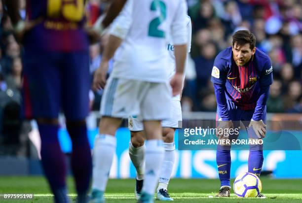 Barcelona's Argentinian forward Lionel Messi looks on during the Spanish League "Clasico" football match Real Madrid CF vs FC Barcelona at the...