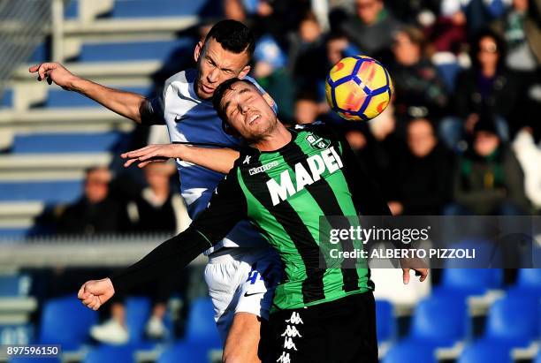 Inter Milan's Croatian forward Ivan Perisic vies for the ball with Sassuolo's Spanish defender Pol Lirola during the Italian Serie A football match...