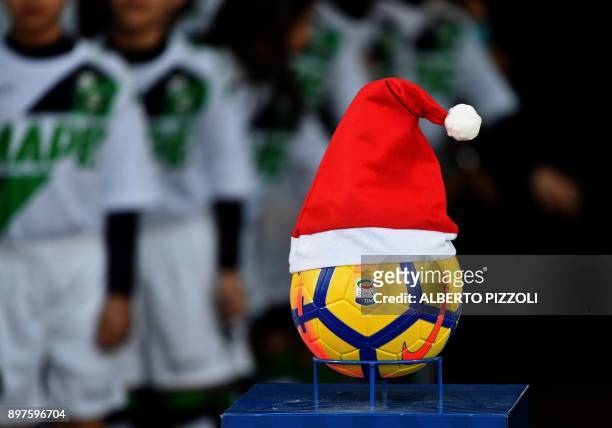 Serie A football with a Santa Claus hat placed on it is diplayed before the Italian Serie A football match Sassuolo vs Inter Milan on December 23,...