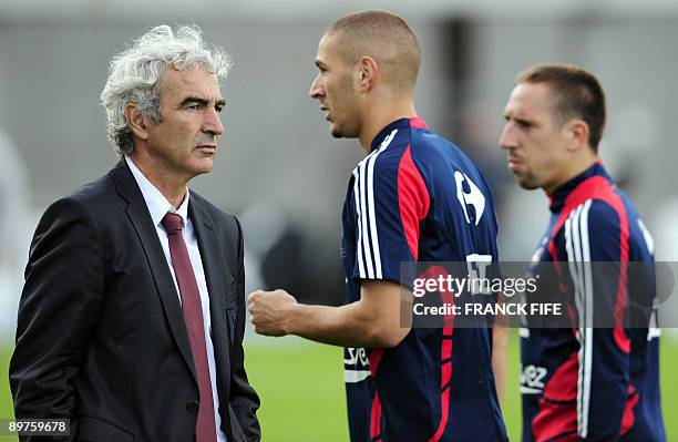 French national football team coach Raymond Domenech is pictured next to forwards Karim Benzema and Franck Ribery during the World Cup 2010...