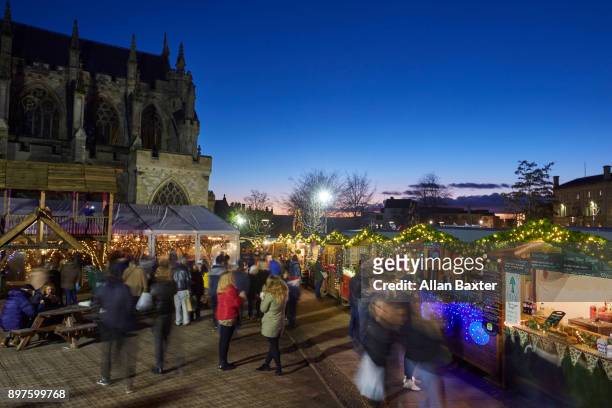 christmas market outside the gothic cathedral in exeter - exeter england stock pictures, royalty-free photos & images