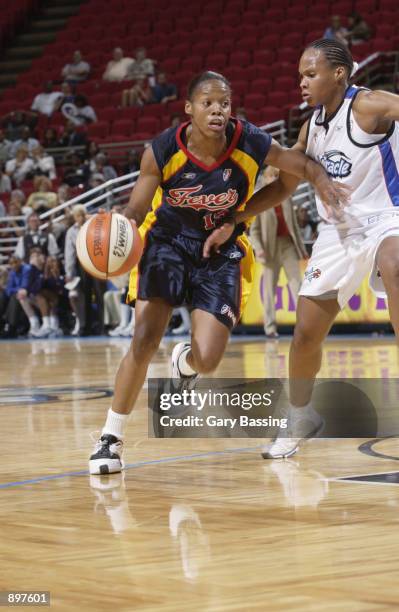 Nikki McCray of the Indiana Fever goes up againt Elaine Powell of the Orlando Miracle in the game on June 11, 2002 at TD Waterhouse Centre in...