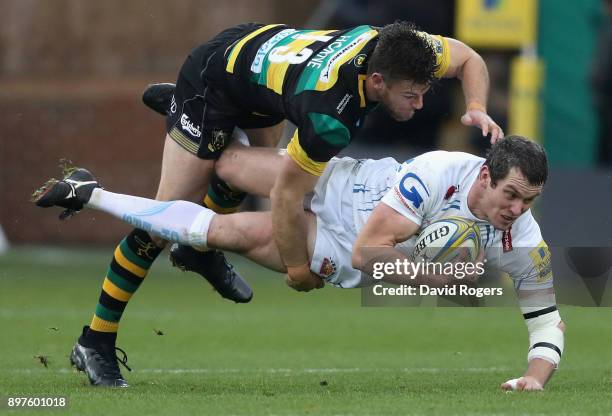 Ian Whitten of Exeter Chiefs is tackled by Rob Horne during the Aviva Premiership match between Northampton Saints and Exeter Chiefs at Franklin's...