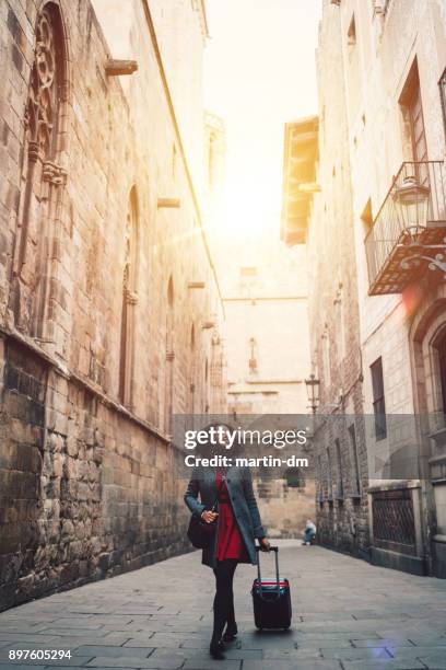 businesswoman enjoying the beauty of barcelona - woman suitcase stock pictures, royalty-free photos & images