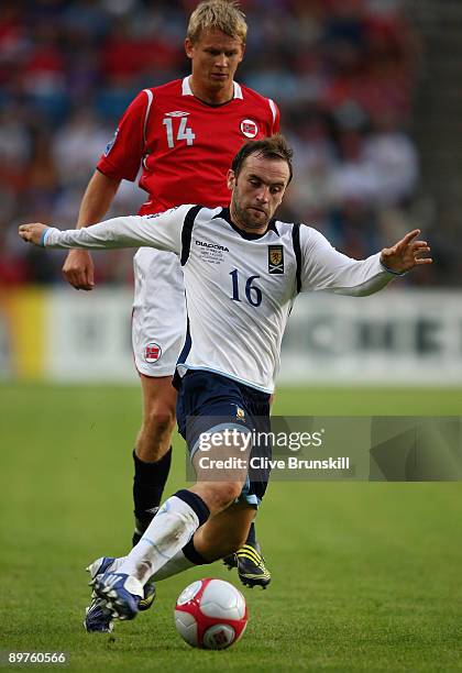 James McFadden of Scotland attempts to move away from Steffen Iversen of Norway during the FIFA 2010 group nine World Cup Qualifying match between...