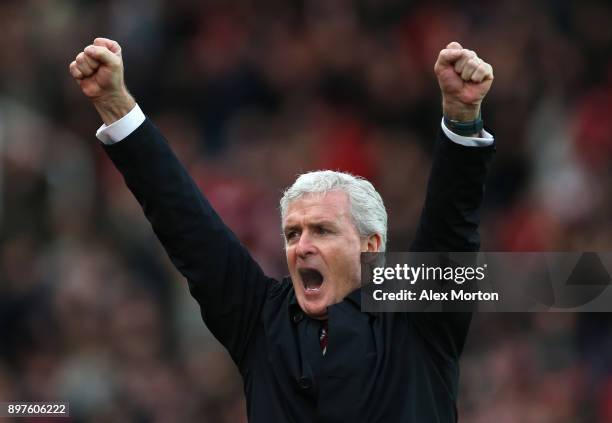 Mark Hughes, Manager of Stoke City celebrates his sides first goal during the Premier League match between Stoke City and West Bromwich Albion at...