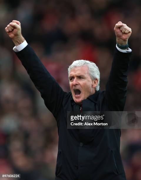 Mark Hughes, Manager of Stoke City celebrates his sides first goal during the Premier League match between Stoke City and West Bromwich Albion at...