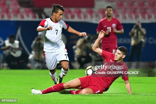 Yemen's Ahmed Abdulhakim Al-Sarori vies for the ball with Qatar's Karim Boudiaf during their 2017 Gulf Cup of Nations football match between Qatar...