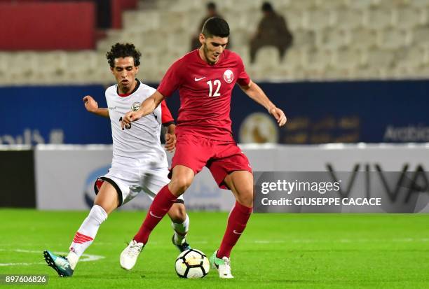 Yemen's Alos Ahmed Abdullah vies for the ball with Qatar's Karim Boudiaf during their 2017 Gulf Cup of Nations football match between Qatar and Yemen...