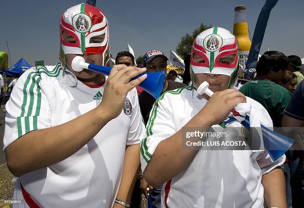 Mexican fans wearing wrestlers' masks ch