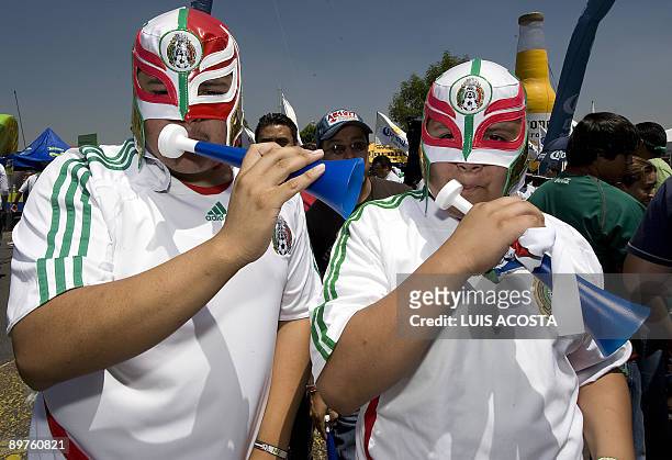 Mexican fans wearing wrestlers' masks cheer his team before the FIFA World Cup South Africa-2010 football qualifier between Mexico and the US at the...
