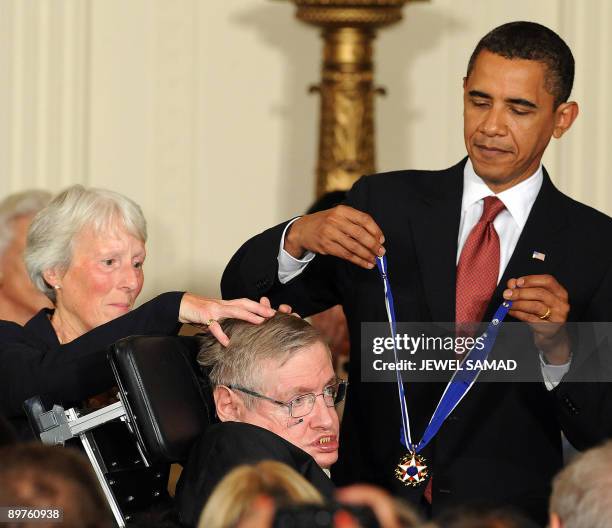 President Barack Obama presents the Presidential Medal of Freedom to British theoretical physicist Stephen Hawking during a ceremony in the East Room...