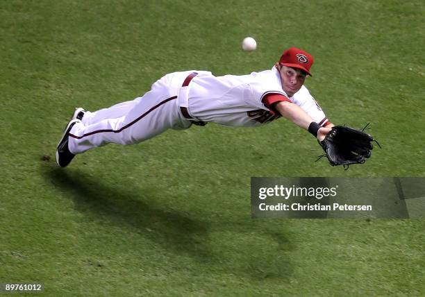 Outfielder Trent Oeltjen of the Arizona Diamondbacks makes a diving catch on a ball hit by Jeff Francoeur of the New York Mets during the first...