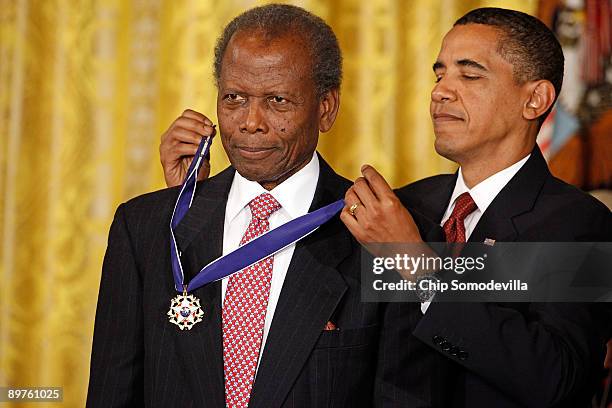 President Barack Obama presents the Medal of Freedom to Academy Award-winning actor Sidney Poitier during a ceremony in the East Room of the White...