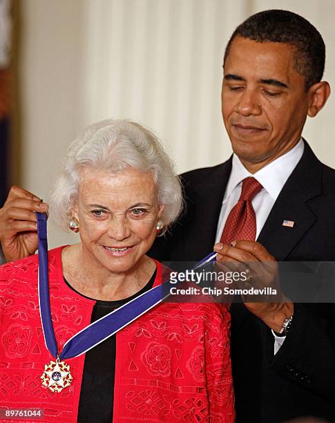 President Barack Obama presents the Medal of Freedom to retired Supreme Court Justice Sandra Day O'Connor during a ceremony in the East Room of the...