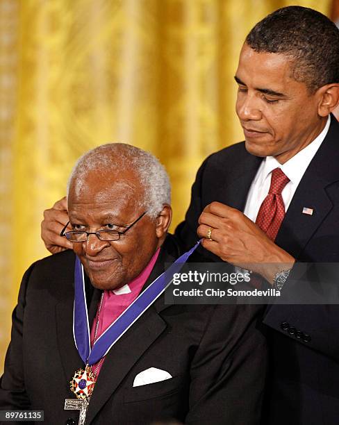 President Barack Obama presents the Medal of Freedom to Bishop Desmond Tutu during a ceremony in the East Room of the White House August 12, 2009 in...
