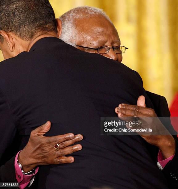 President Barack Obama embraces Bishop Desmond Tutu after presenting him with the Medal of Freedom during a ceremony in the East Room of the White...