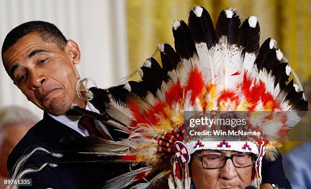 President Barack Obama struggles to present the Medal of Freedom to Dr. Joseph Medicine Crow - High Bird during a ceremony at the White House August...