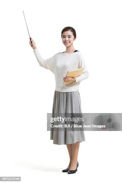 young female teacher holding teachers pointer - pointer stick stock pictures, royalty-free photos & images
