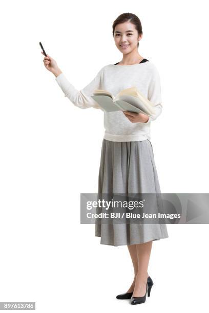 young female teacher teaching with textbook - showing pen stock pictures, royalty-free photos & images