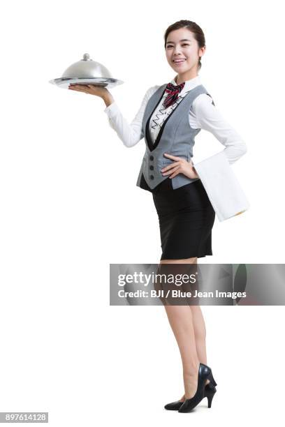 smiling waitress in hotel with serving tray - silbertablett stock-fotos und bilder