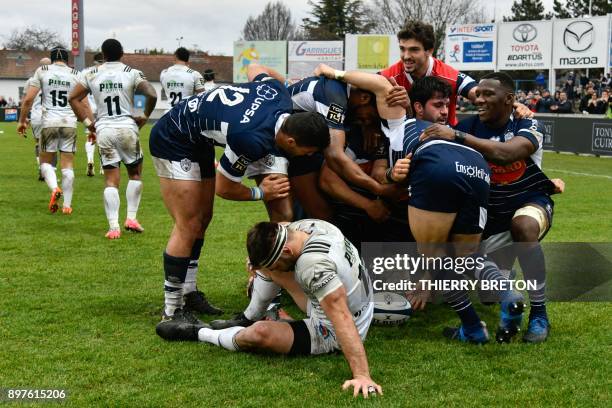 Agen's players celebrate a try by Argentinian hooker Facundo Bosch during the French Top 14 rugby union match between SU Agen and Brive on December...