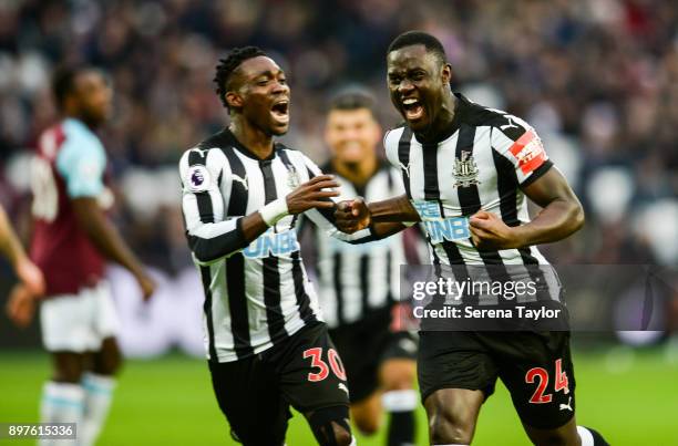 Henri Saivet of Newcastle United celebrates with teammate Christian Atsu after he scores from a free kick to equalise during the Premier League match...