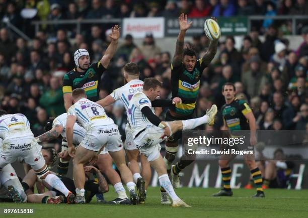 Will Chudley of Exeter kicks the ball upfield as Courtney Lawes attempts to block during the Aviva Premiership match between Northampton Saints and...