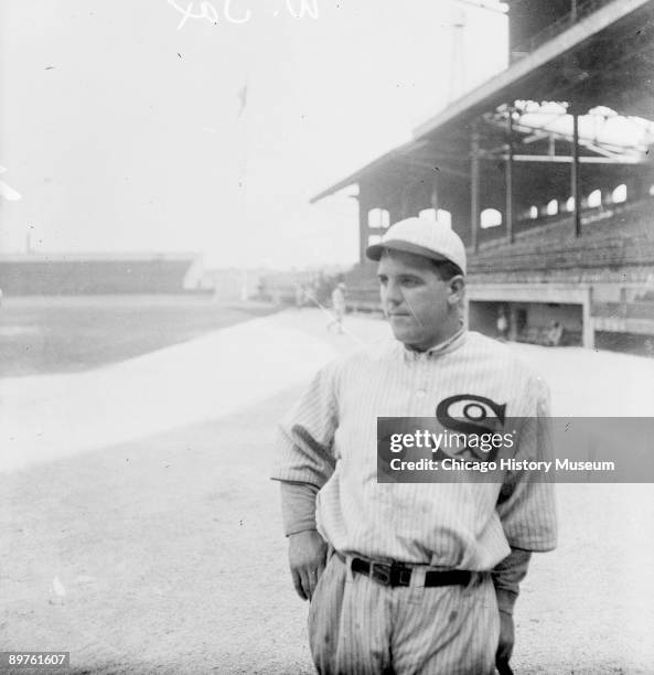 Informal three-quarter length portrait of baseball player Eddie Cicotte of the American League's Chicago White Sox, leaning on a baseball bat,...