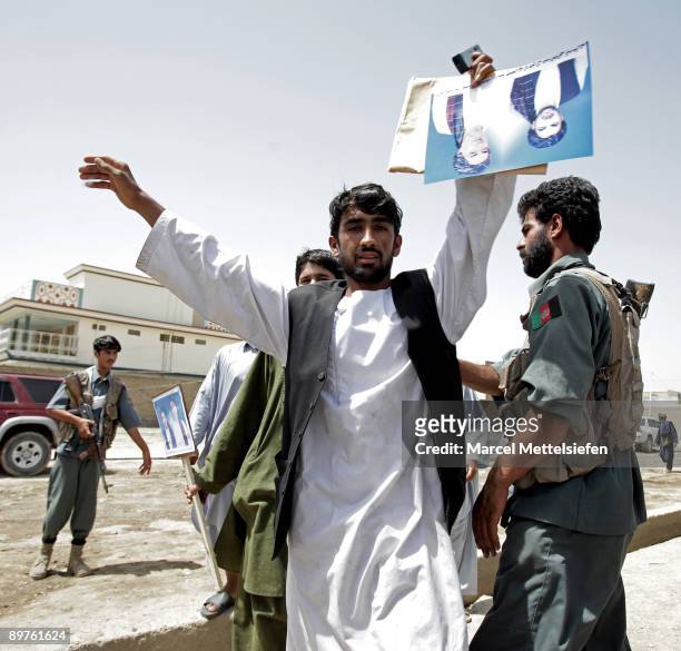 Supporters of the presidential candidate and former Foreign Minister Abdullah Abdullah are checked by security before entering a campaign rally on...