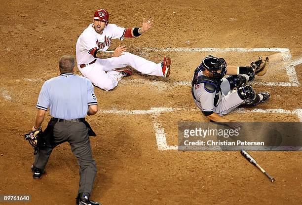 Ryan Roberts of the Arizona Diamondbacks reacts to home plate umpire Mike Everitt after being tagged out at the plate by catcher Omir Santos of the...
