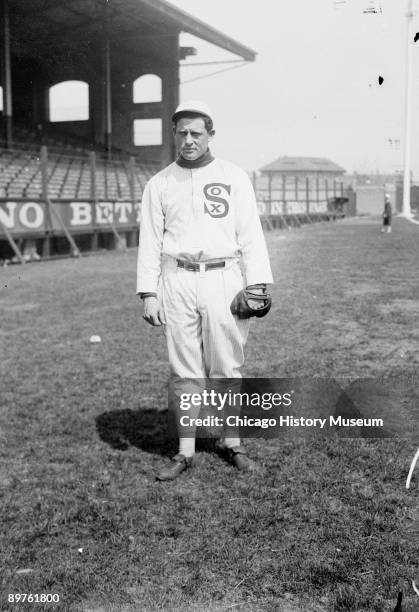Informal full-length portrait of baseball player Ed Walsh of the American League's Chicago White Sox, standing on the field at Comiskey Park,...